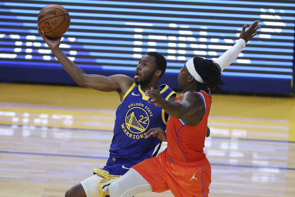 Golden State Warriors' Andrew Wiggins, left, shoots against Oklahoma City Thunder's Luguentz Dort during the first half of an NBA basketball game in San Francisco, Saturday, May 8, 2021. (AP Photo/Jed Jacobsohn)