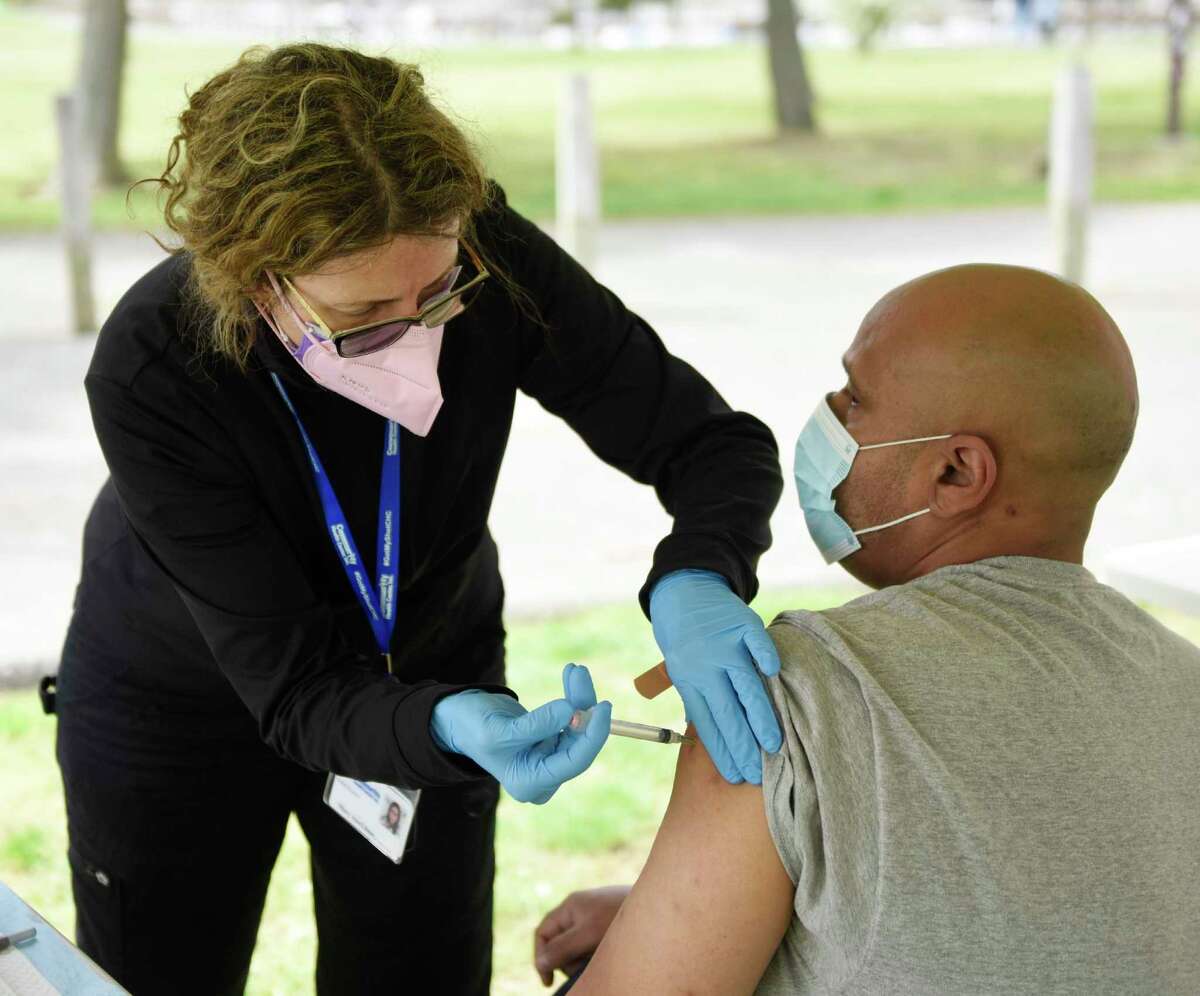 Stamford's Jose Virella gets vaccinated by Mary Ann Llinas at the Community Health Centers walk-in COVID-19 vaccination clinic at Cove Island Park in Stamford, Conn. Sunday, May 2, 2021. CCH provided patients with the single-dose Johnson & Johnson vaccine Sunday with no appointment necessary.