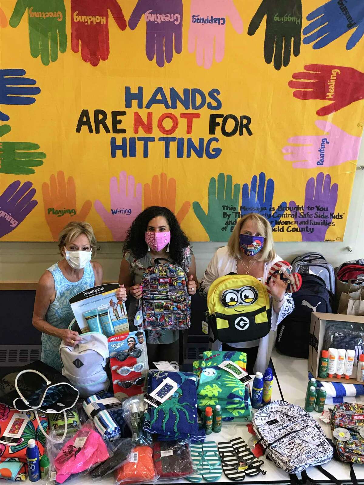 Rita Bailey, left, executive director of the Darien Domestic Abuse Council, Sasha Collins, Camp Hope Coordinator and Youth Trauma Specialist and Debra Greenwood, The Center for Family Justice president with last year's donations.