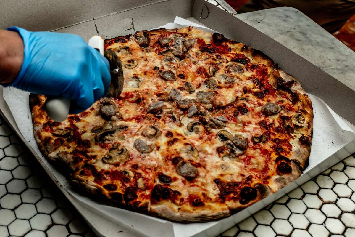 Hot pizza getting cut and boxed at Frank Pepe's in New Haven on April 23, 2021.