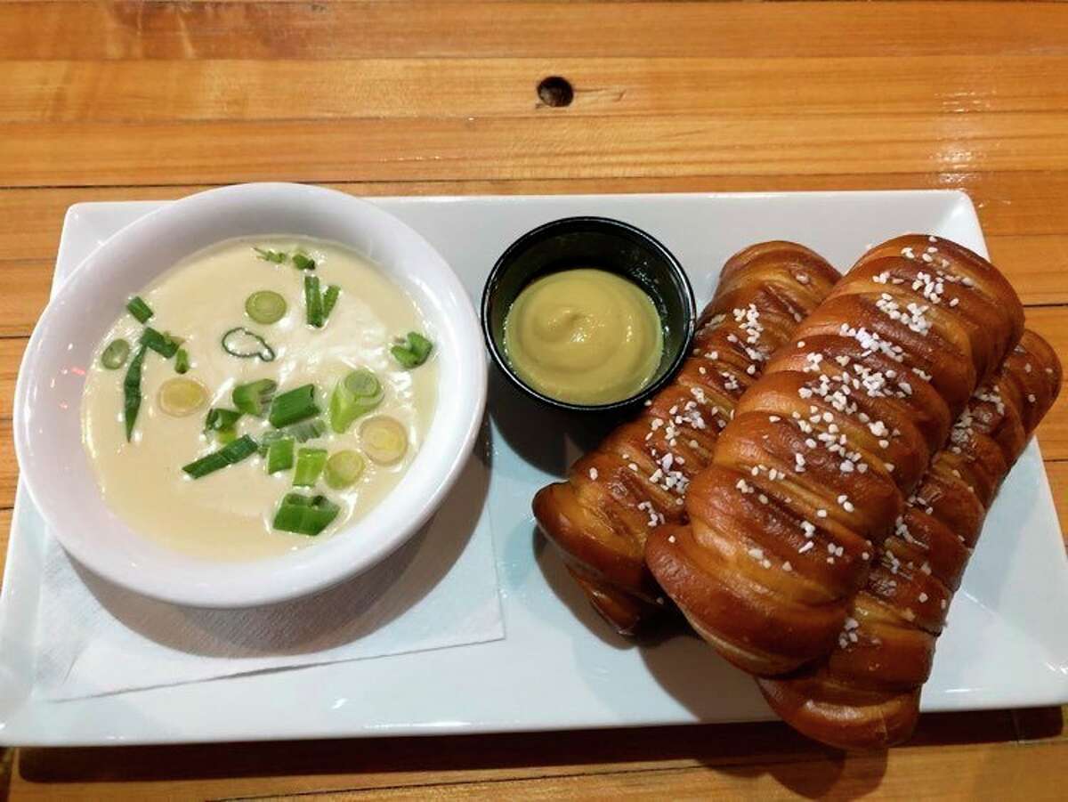 I started my meal at Whichcraft Taproom with an order of Bavarian pretzels. They were accompanied by a side of house-made creamy beer cheese and spicy Dijon mustard. (Victoria Ritter/vritter@mdn.net)