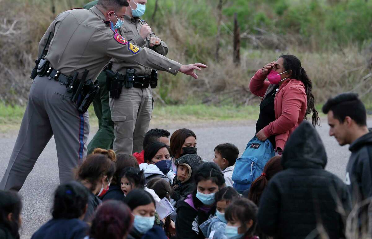 Texas Department of Public Safety troopers help in the detention of a group of around 40 migrants, some unaccompanied minors, west of La Joya, Texas, Friday, April 2, 2021.