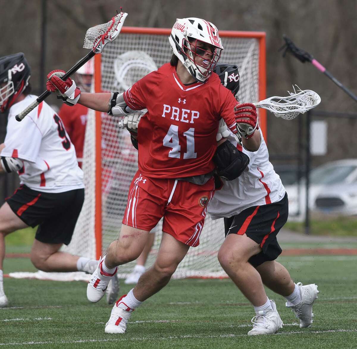 Fairfield Prep’s Peter Grandolfo (41) battles the New Canaan defense during a game in April.