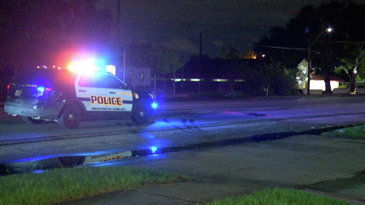 San Antonio police examine the scene where a woman was fatally struck by a truck about 9:30 p.m. Tuesday in the 2000 block of South W.W. White Road.