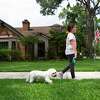Maya Stanton, 10, walks her dog, Abbey Road, after school on Tuesday, May 4, 2021, in Houston. Maya and her twin brother Max, both walk their dogs as an after school chore.