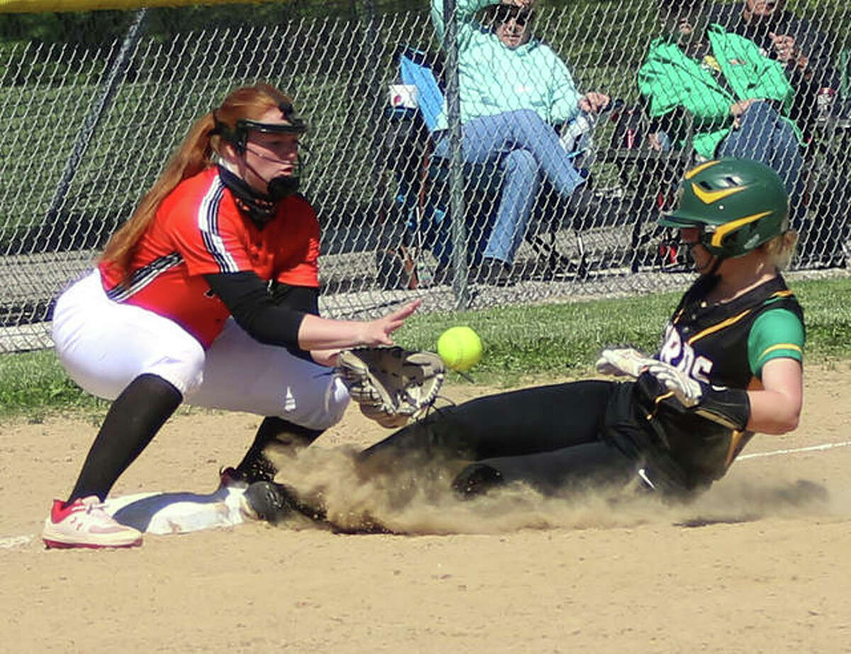 Southwestern’s Bri Roloff slides in safe with a triple as Edwardsville third baseman Brooke Tolle (left) takes the throw with two outs in the sixth inning Wednesday afternoon in Piasa.