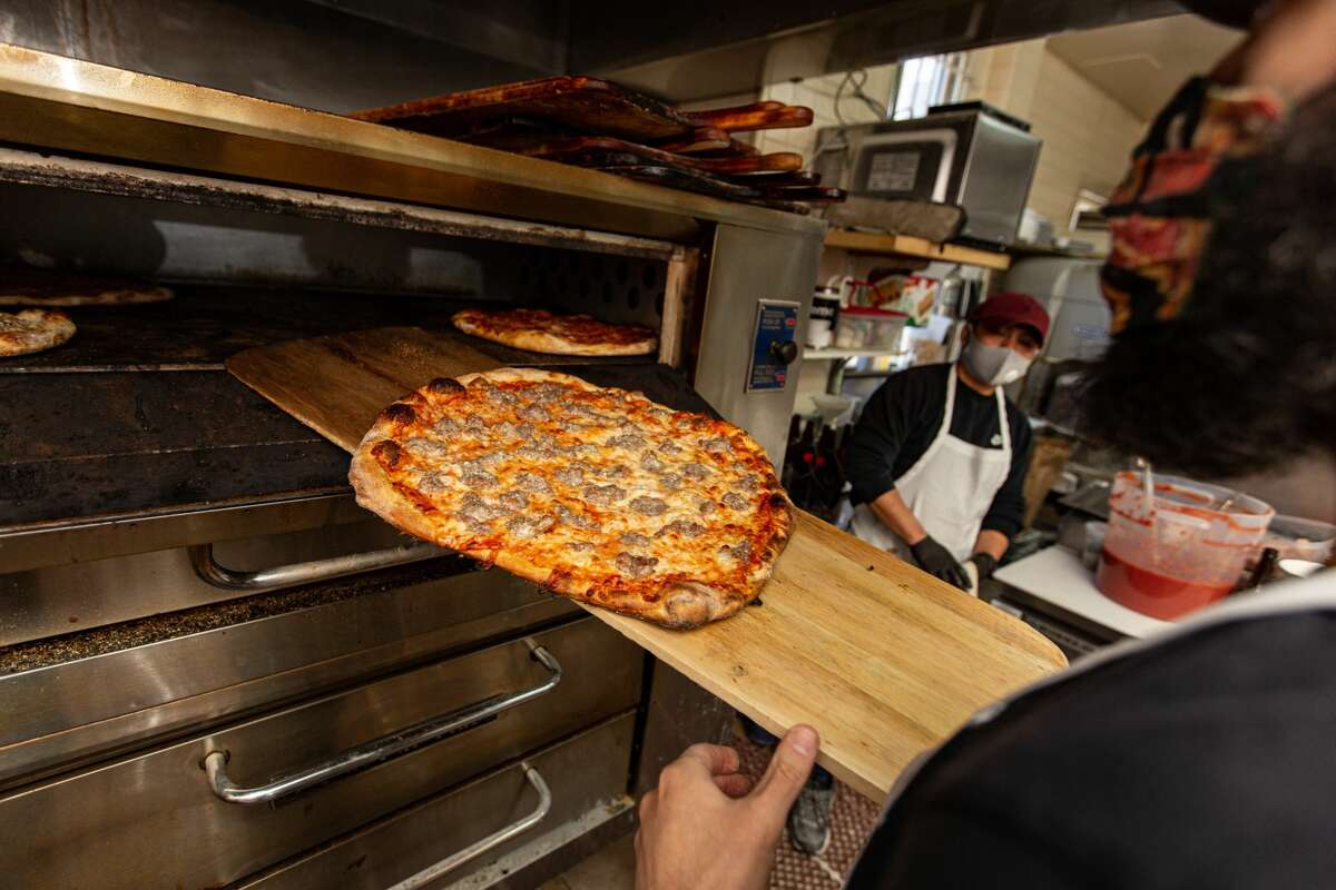 Pizza coming out of the oven at Zuppardi's in West Haven on April 23, 2021.