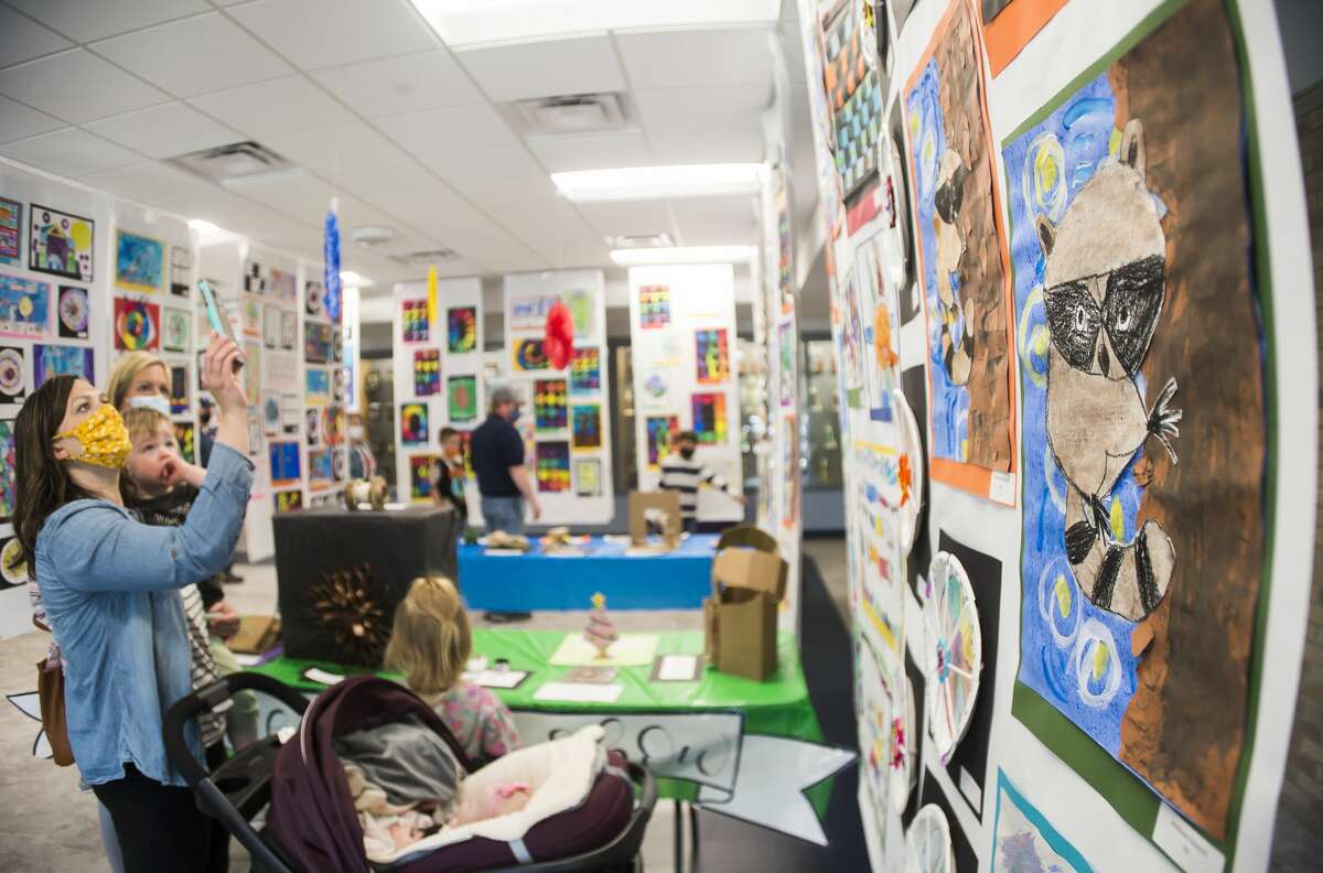 Families browse works of art during the Meridian Public Schools art show Wednesday, May 12, 2021 at Meridian Early College High School in Sanford. (Katy Kildee/kkildee@mdn.net)
