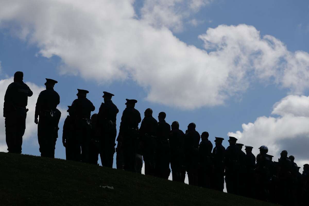 Police officers and other law enforcement are seen during the annual police memorial in honor of Sgt. Ed Holcomb, Jr. at Heritage Park, Thursday, May 13, 2021, in Conroe. The event, which was held virtually last year, honors Holcomb and other officers who have died in the line of duty as part of National Police Week.