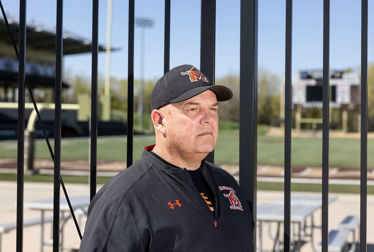 A portrait of Terry Bahlmann, head football coach at Marshall High School, outside of the game field in Marshall, Minn., on Tuesday, May 11, 2021.