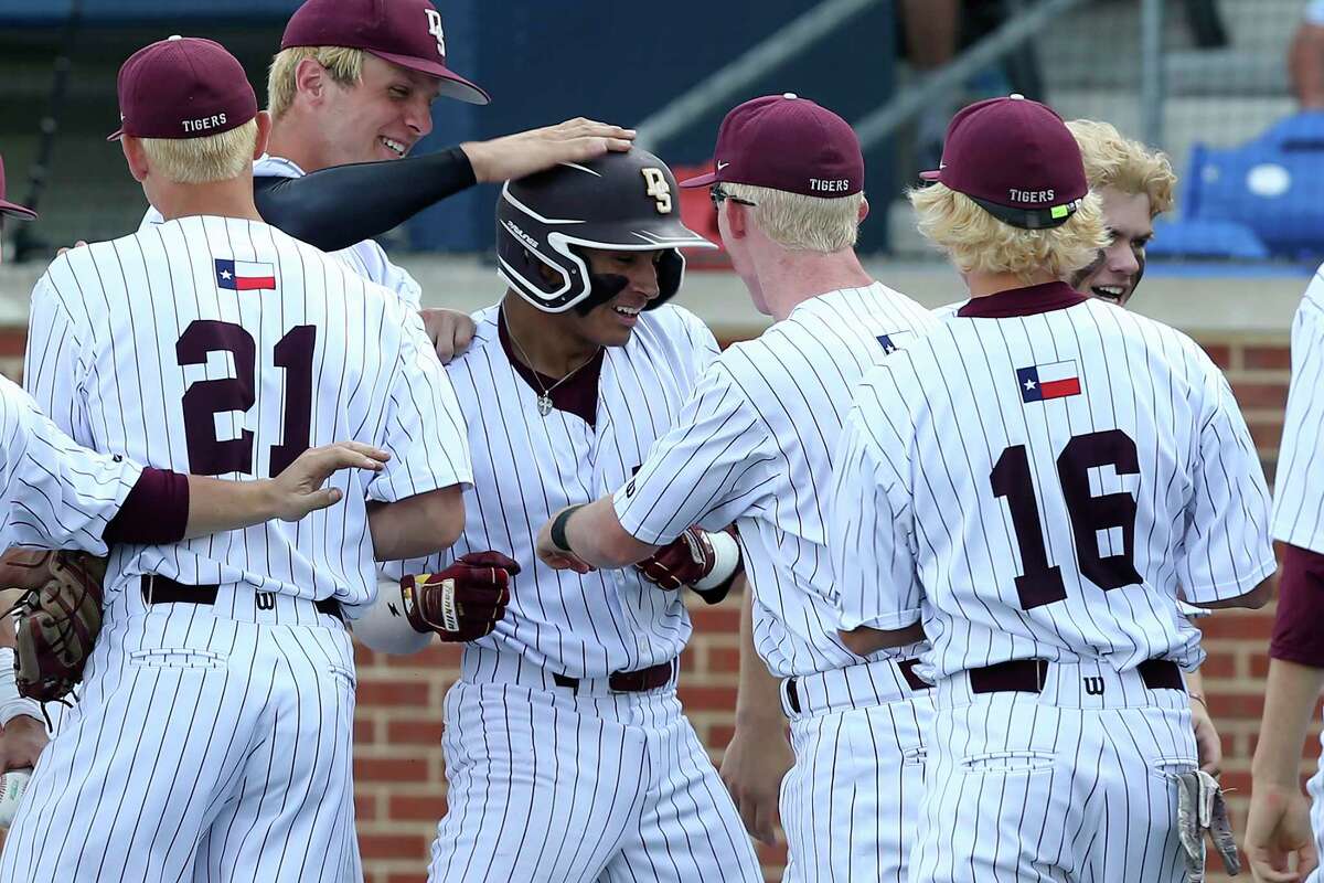 Dripping SpringÕs players surround Nico Ruedas after his three-run hit at the bottom of the fifth against Jefferson at North East Sports Park, Thursday, May 13, 2021. Dripping Springs went on to win the District 5A second round game, 5-0.