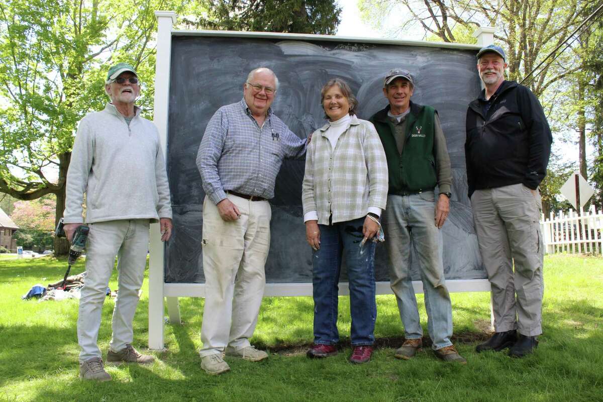 Jeff Vreeland, left, John Ward, Bonnie and Phil Kearns and Senior Pastor Bill Pfohl, of Jesse Lee Memorial United Methodist Church, pose outside the parish’s Prayer Wall, an intitative aimed at bringing congregants and non-congregants together to share their hopes, desires and concerns as the world returns to normal.