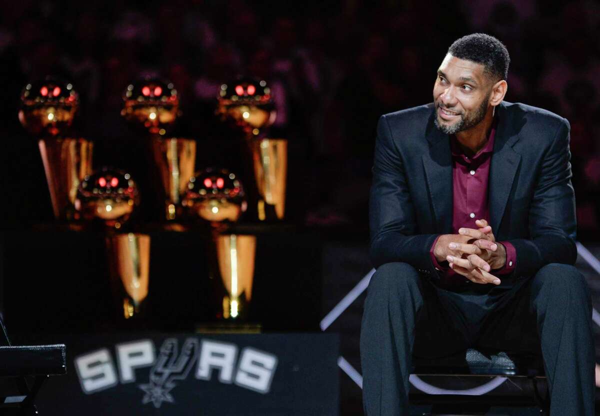 FILE - In this Dec. 18, 2016, file photo, San Antonio Spurs' Tim Duncan listens while special guests speak about him during his jersey retirement ceremony in San Antonio. Joining Kobe Bryant as first-time finalists for the Basketball Hall of Fame are: 15-time All-Star Duncan, fellow 15-time All-Star Kevin Garnett and 10-time WNBA All-Star and four-time Olympic gold medalist Tamika Catchings. (AP Photo/Darren Abate, File)