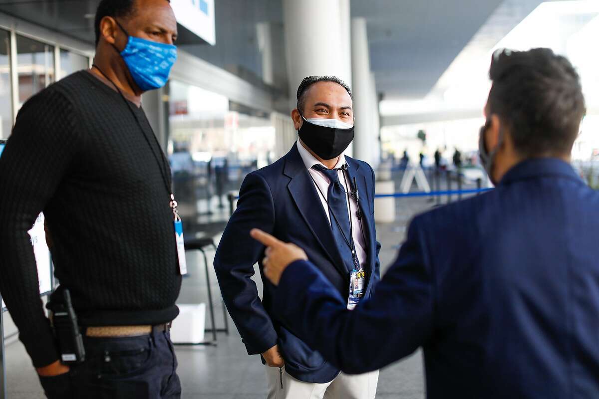 Security personnel at Moscone Center in San Francisco wear double masks on Feb. 12, 2021.