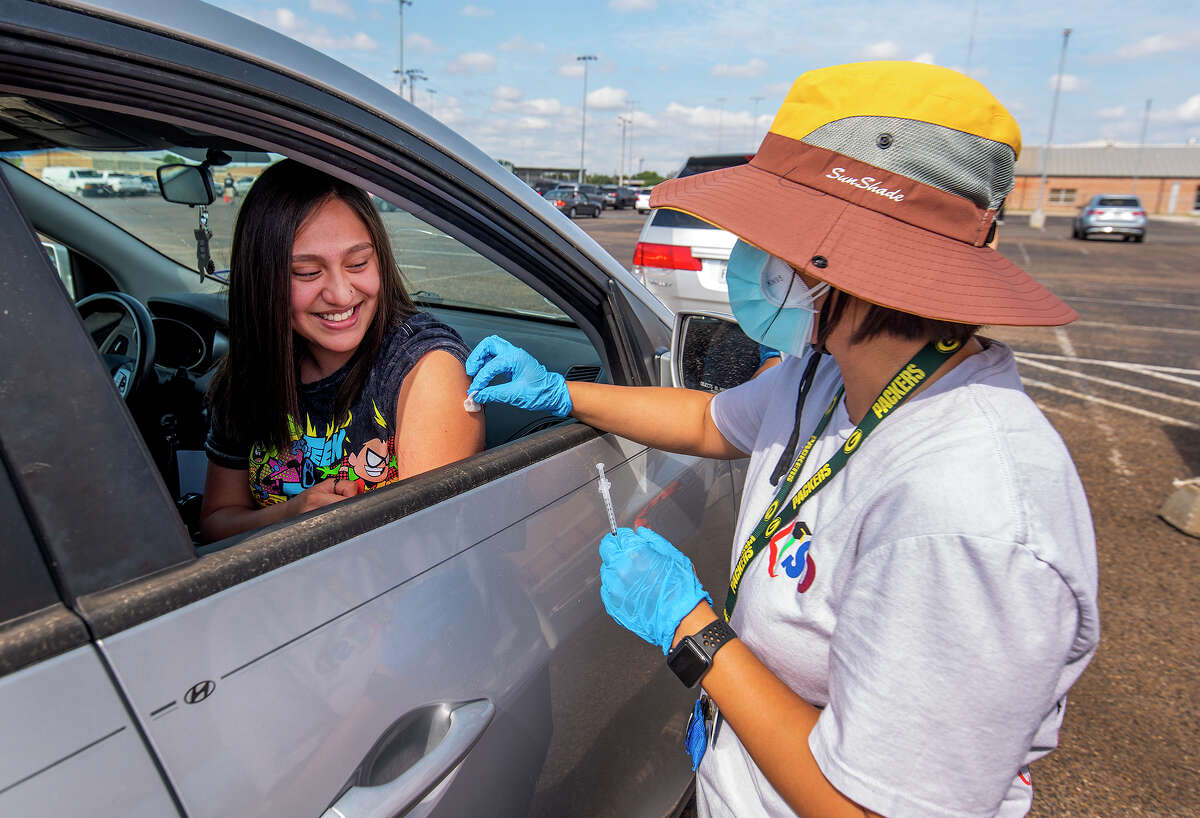 Martin High School sophomore Kylie Lopez gets her Covid-19 shot from LISD Registered Nurse Mary Tijerina, Friday, May 14, 2021, at Shirley Field during a vaccination drive for students.