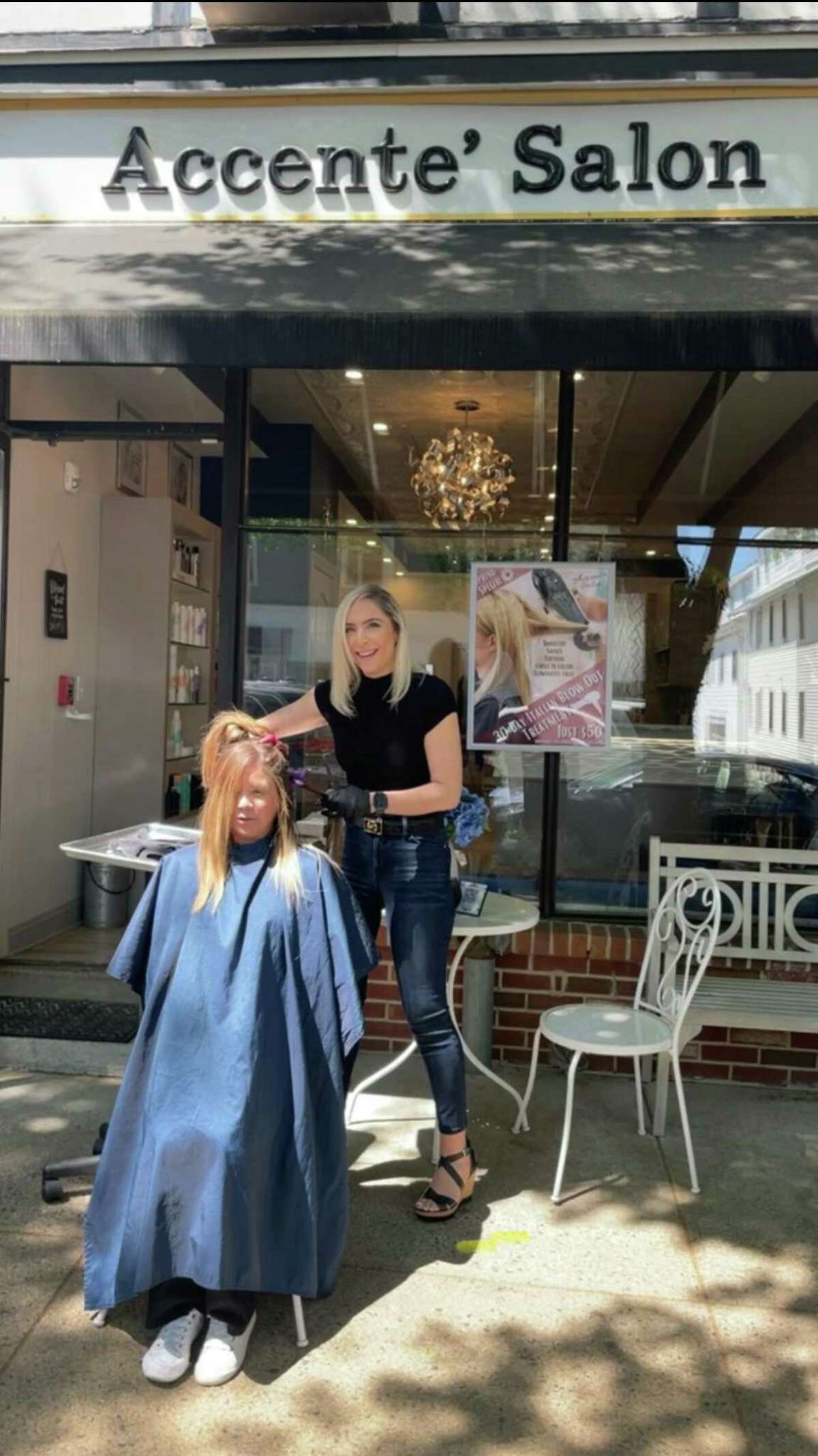 Tiffany Broderick, a manager at Accenté Salon, works on client Lynette Gilliand's hair outside of the Ridgefield location Friday. While working outside, Broderick found at least three new clients, including one who said she only felt comfortable getting her hair done outside.