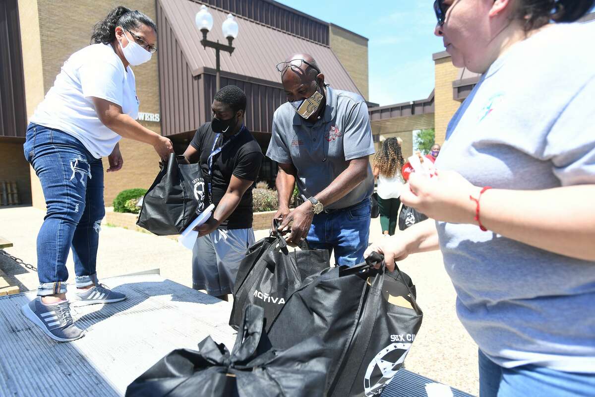 Susan Contreras (left) and Susan Gonzalez with the SETX Civilian Task Force hand out bags filled with supplies during Southeast Texas Stand Down 2021 in Port Arthur Friday. Numerouse veterans organizations as well as other health and community action services filled the Bob A. Bowers Civic Center for the event, which aims to connect veterans and the homeless with needed resources. A fall event will be held in Beaumont. Photo made Friday, May 14, 2021 Kim Brent/The Enterprise