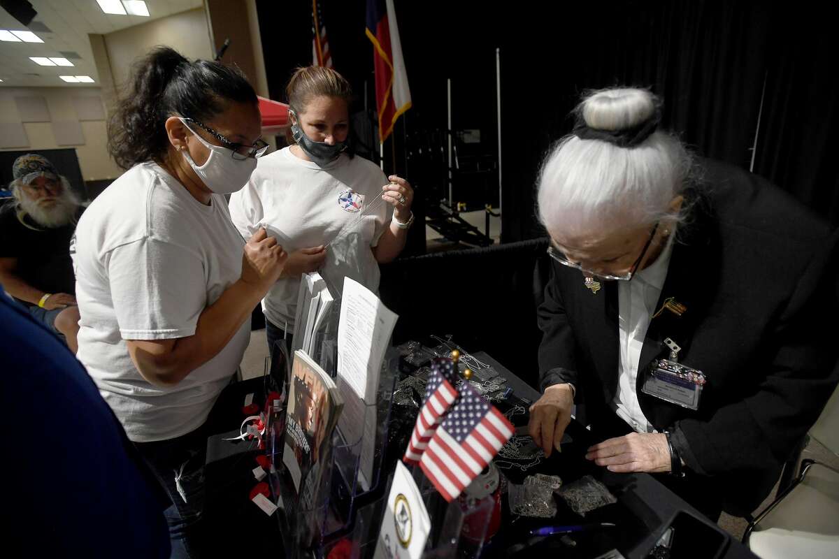 Susan Contreras (left) and Autumn Brown with SETX Civilian Task Force select specialty dog tags for family at the VFW Post 4820 as Dorothy Peyton assists them during Southeast Texas Stand Down 2021 in Port Arthur Friday. Numerous veterans organizations as well as other health and community action services filled the Bob A. Bowers Civic Center for the event, which aims to connect veterans and the homeless with needed resources. A fall event will be held in Beaumont. Photo made Friday, May 14, 2021 Kim Brent/The Enterprise