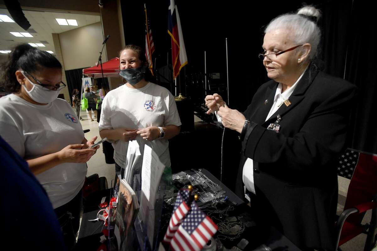 Susan Contreras (left) and Autumn Brown with SETX Civilian Task Force select specialty dog tags for family at the VFW Post 4820 as Dorothy Peyton assists them during Southeast Texas Stand Down 2021 in Port Arthur Friday. Numerous veterans organizations as well as other health and community action services filled the Bob A. Bowers Civic Center for the event, which aims to connect veterans and the homeless with needed resources. A fall event will be held in Beaumont. Photo made Friday, May 14, 2021 Kim Brent/The Enterprise