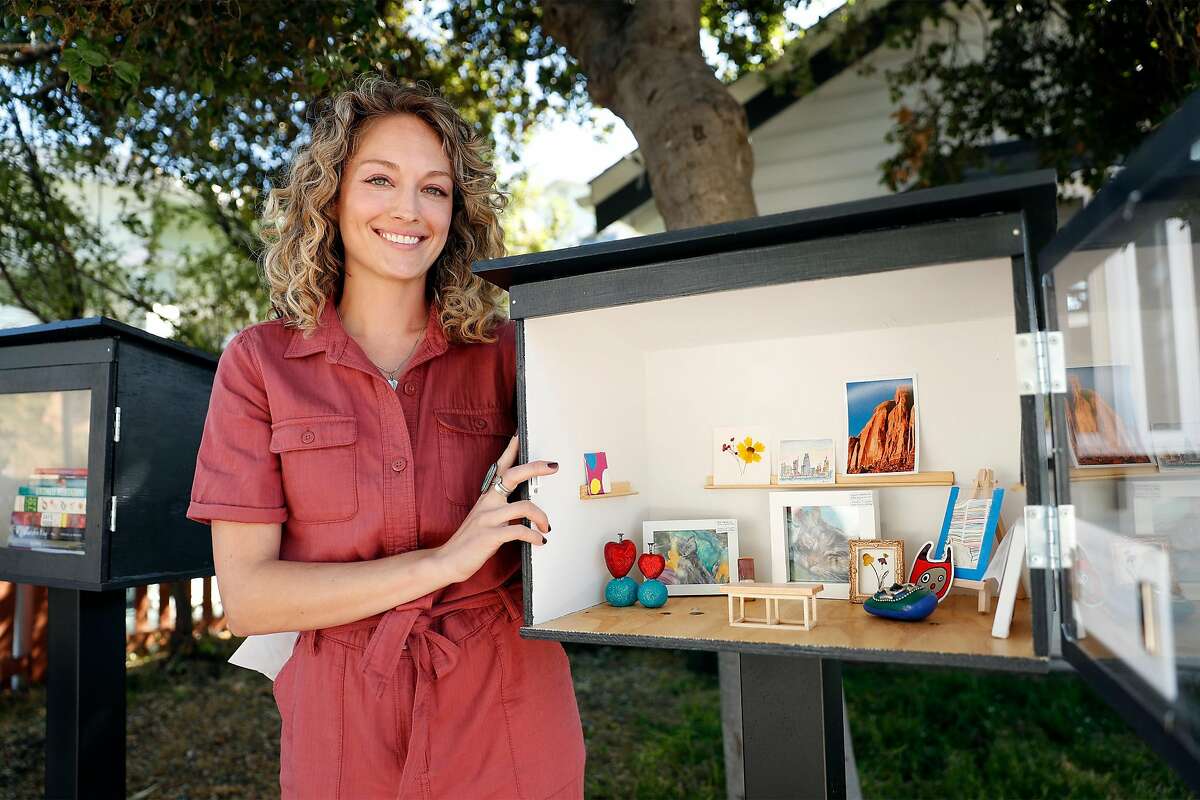 Allie St. Amand displays the little free gallery in front of her Oakland home. A bench for tiny art lovers is part of the setup.