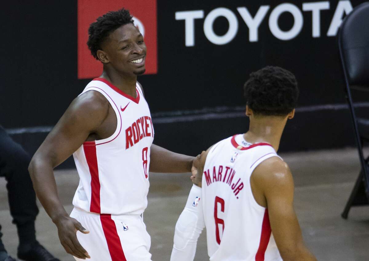 Houston Rockets forward Jae'Sean Tate (8) celebrates after a play with Houston Rockets forward Kenyon Martin Jr. (6) during the third quarter of an NBA game between the Houston Rockets and the LA Clippers on Friday, May 14, 2021, at Toyota Center in Houston.