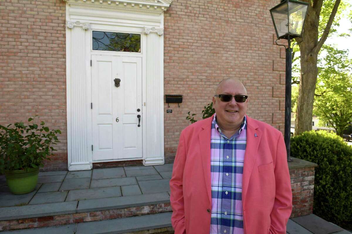 Ted Hine, of New Milford, stands in front of a door the the New Milford Historical Society on Tuesday morning. Hine's family is one of the towns first families and he has lived in New Milford his whole life. The door comes from the United States Hotel, which was located at Main and Bank Streets and was built by his ancestor, Beebe Hine. May 11, 2021, in New Milford, Conn.