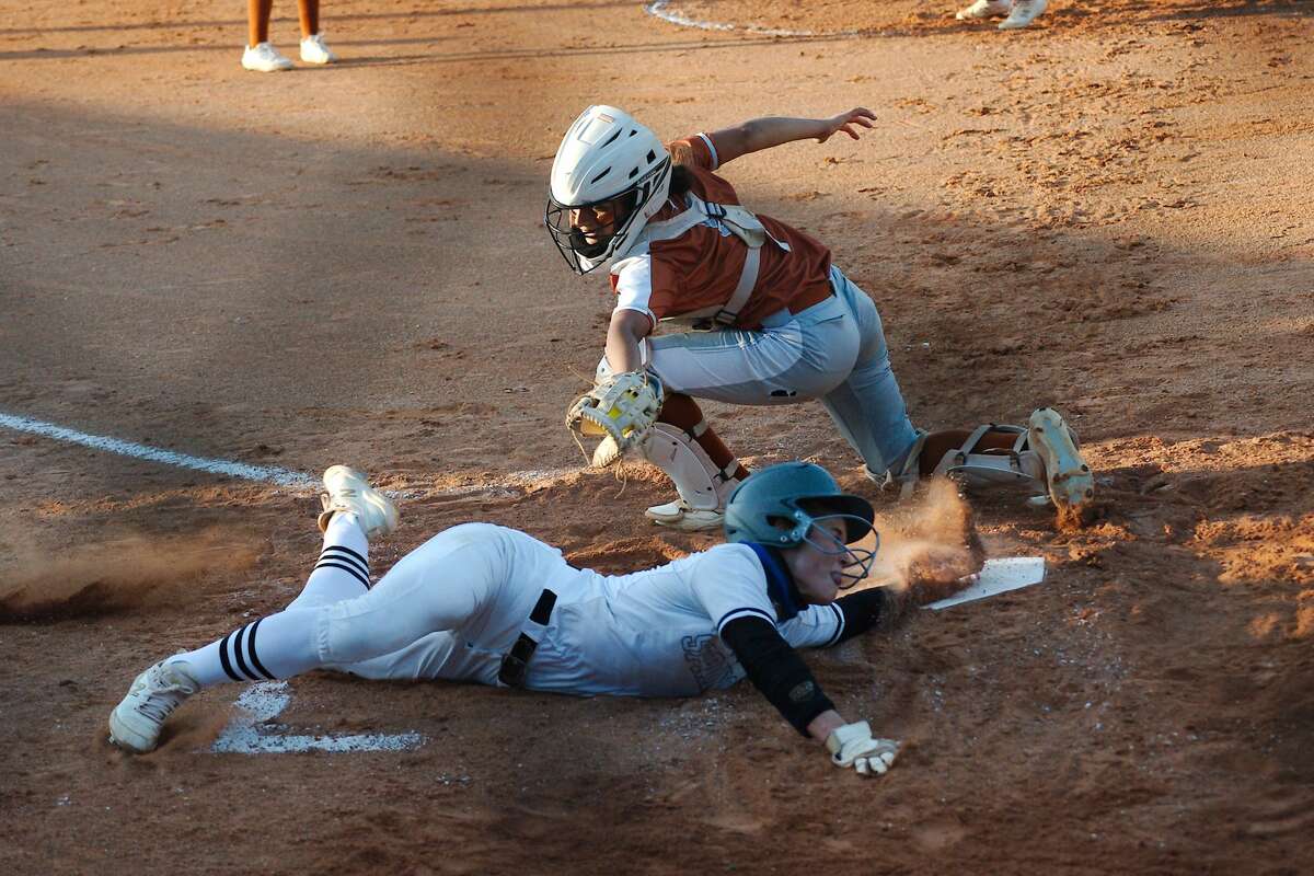 Clear Springs' Demi Elder (2) is ruled out by after the tag by Dobie's Bella Perez (5) at home plate Friday, May 14 at La Porte High School.