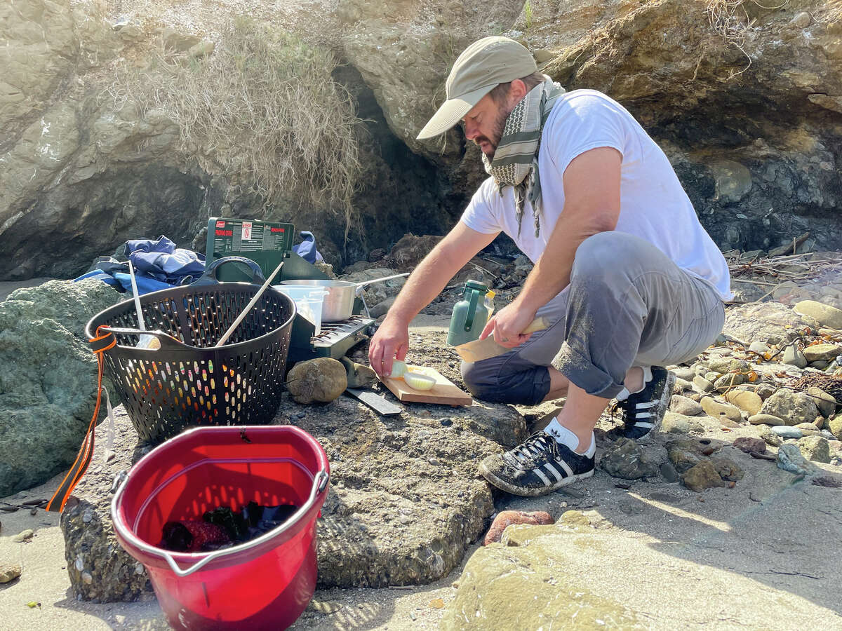 Chopping onion for seaweed ramen on a Central Coast beach.