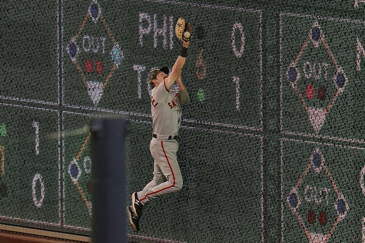 San Francisco Giants right fielder Mike Yastrzemski can't come up with the catch on a fly ball hit by Pittsburgh Pirates' Adam Frazier during the 11th inning of a baseball game in Pittsburgh, Friday, May 14, 2021. Fraizier made it to third on the play, and scored the game winning run of a sacrifice fly by Gregory Polanco. The Pirates won 3-2.(AP Photo/Gene J. Puskar)