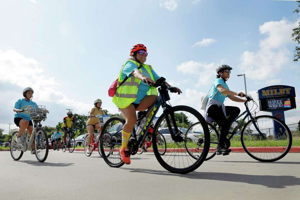 Riders leave the parking lot as they begin this year’s Communities in Schools “Wellness On Wheels” bike ride, part of Mental Health Awareness Week, beginning at Mibly High School Saturday, May. 15, 2021 in Houston, TX. Over 40 riders participated in the ride, which included teens and city leaders.
