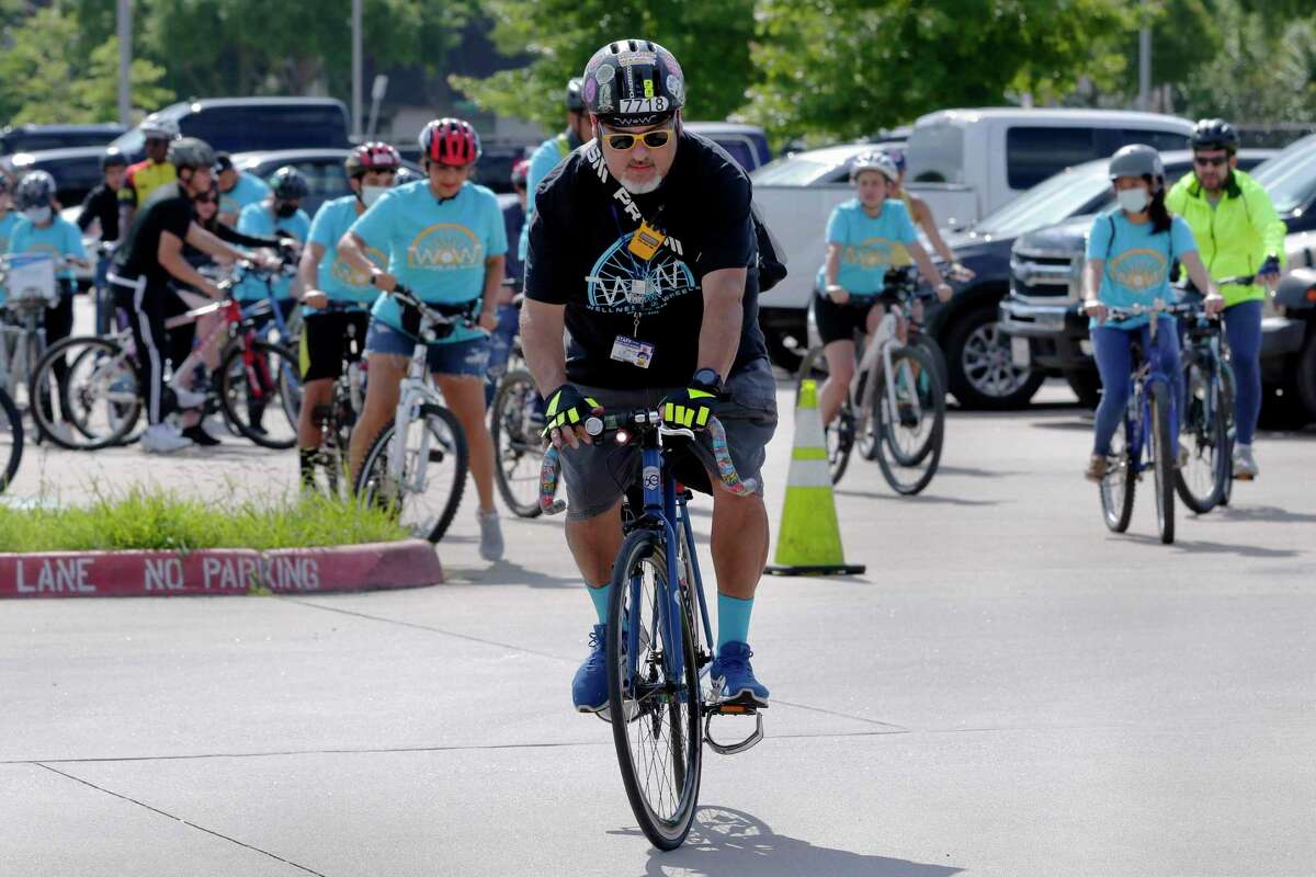 Event organizer and ride leader Rene Gonzalez leads the procession of bikes as they leave the parking lot during this year’s Communities in Schools “Wellness On Wheels” bike ride, part of Mental Health Awareness Week, beginning at Mibly High School Saturday, May. 15, 2021 in Houston, TX. Over 40 riders participated in the ride, which included teens and city leaders.