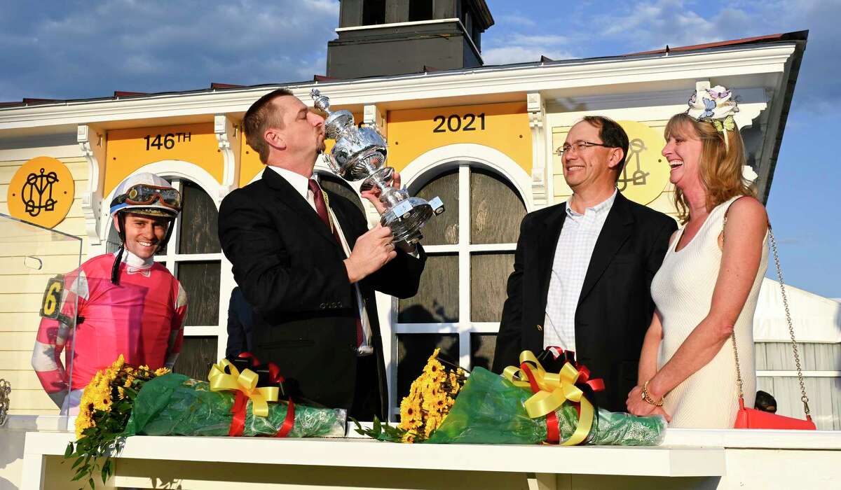 Trainer Mike McCarthy kisses the winner's trophy after Rombauer, with jockey Flavien Prat, won the 146th running of the Preakness Stakes at Pimlico Race Course on Saturday, May 15, 2021. Rombauer won't be running at Saratoga, but McCarthy has Ce Ce in the Ballerina on Saturday.