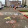 A family moving to the next arts and crafts station at the Art Museum of Southeast Texas's first in-person Family Arts Day on Saturday, May 15, 2021 in Downtown Beaumont,Texas.
