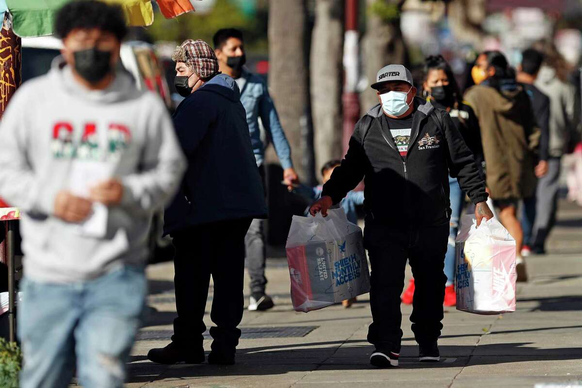 Pedestrians were face coverings on Mission Street in San Francisco, Calif., on Wednesday, February 17, 2021.