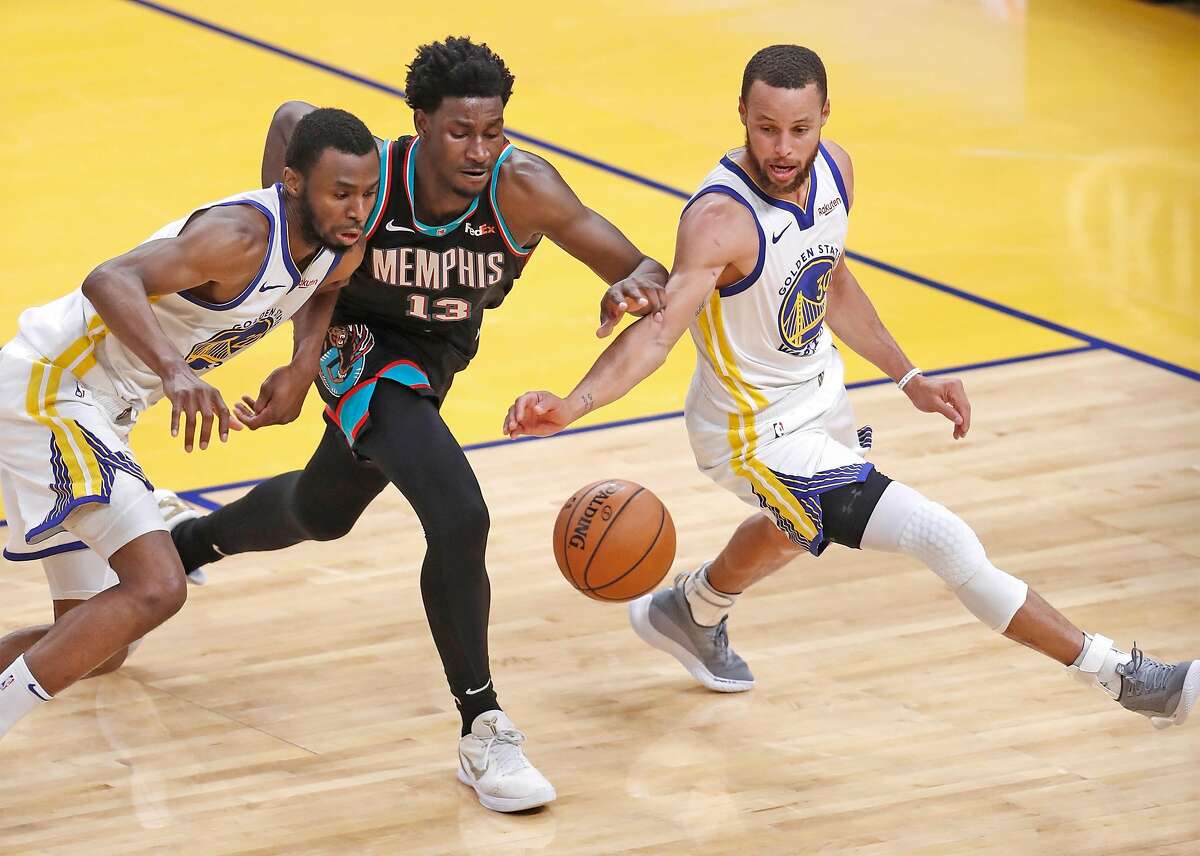 Golden State Warriors' Andrew Wiggins and Stephen Curry vie for a loose ball against Memphis Grizzlies' Jaren Jackson Jr. in 4th quarter during Warriors' 113-101 win in NBA game at Chase Center in San Francisco, Calif., on Sunday, May 16, 2021.