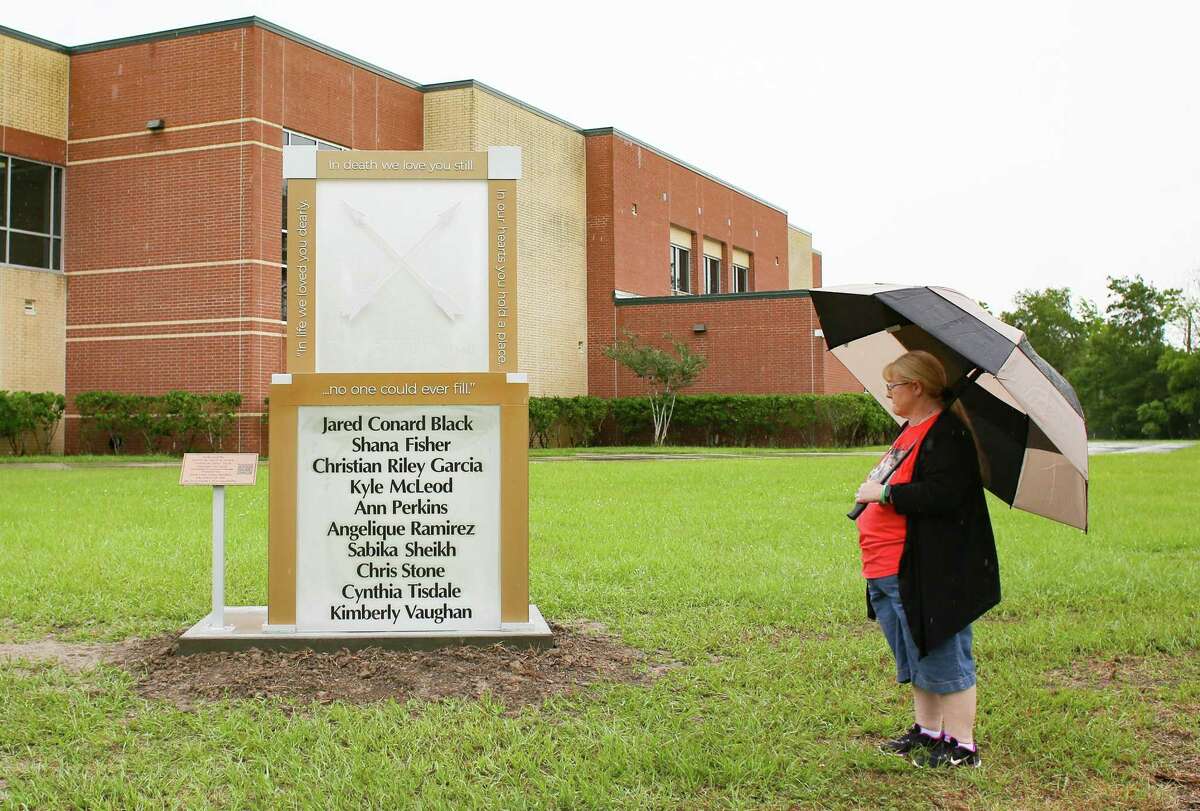 Gail McLeod, mother of Kyle McLeod, looks at a memorial in honor of the victims, including her son, in the 2018 school shoot at Santa Fe High School on Sunday, May 16, 2021. May 18 marks the third year anniversary of the deadly shooting at the school.