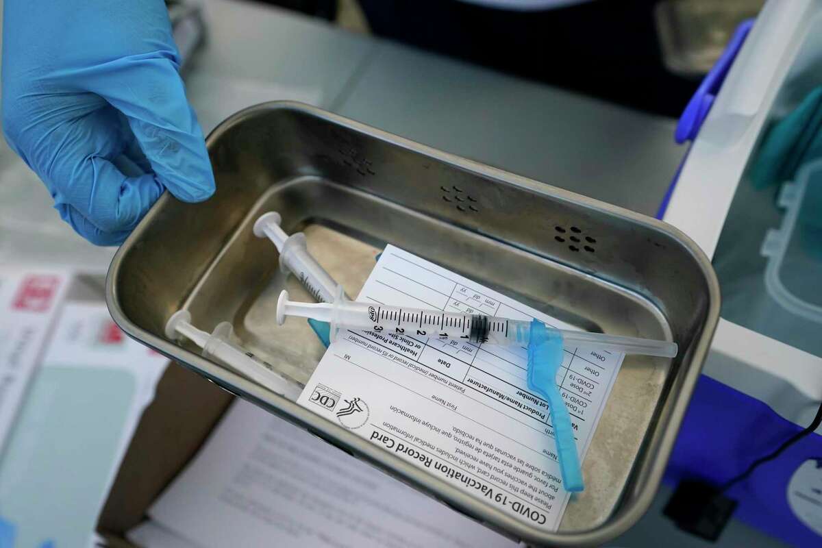 Syringes filled with coronavirus vaccine are shown at a mobile clinic.