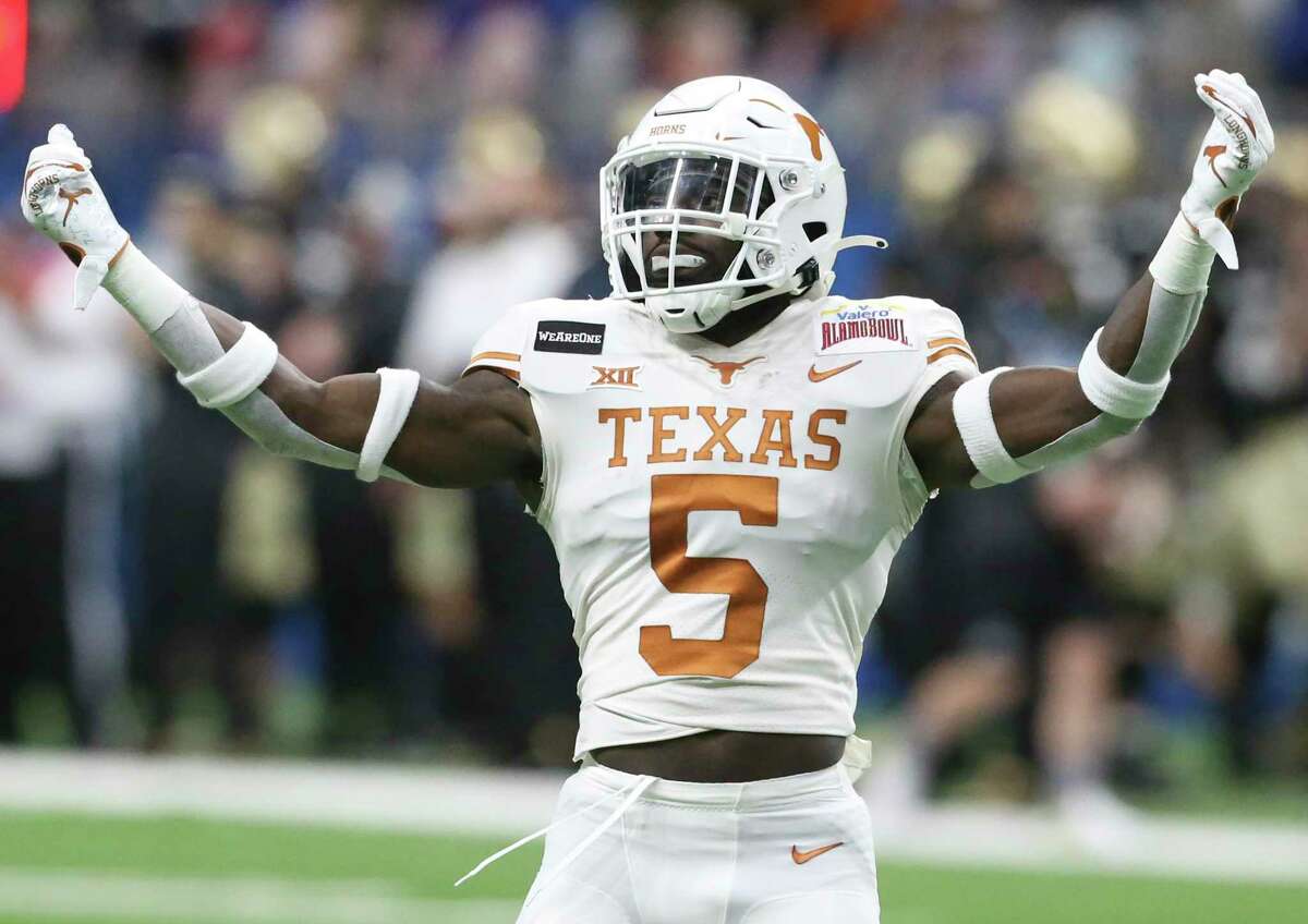 Longhorn running back D'Shawn Jamison celebrates with the crowd during the first quarter as Texas plays Colorado in the Alamo Bowl at the Alamodome on Dec. 29, 2020.