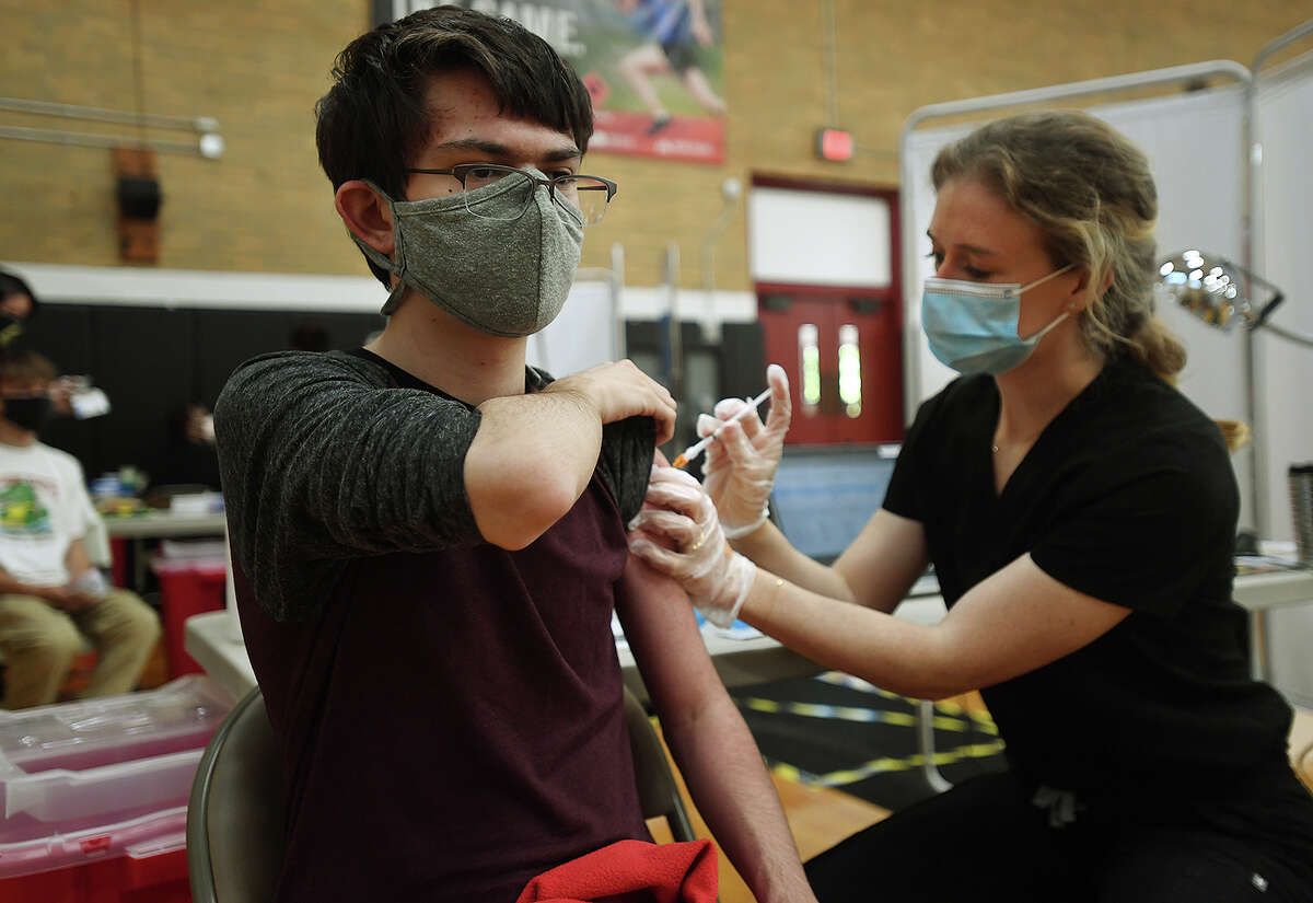 Alexander Pereira, 15, of Milford, receives the Pfizer Covid-19 vaccine from nurse Kaitlin Erickson, APRN, RN, at a Yale New Haven Health vaccination clinic at the Parsons Complex gymnasium in Milford, Conn. on Monday, May 17, 2021.,