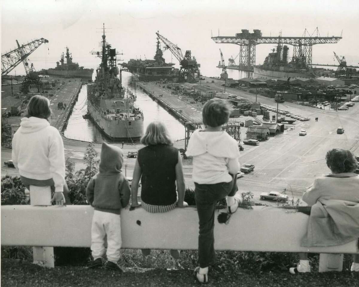 June 17, 1964: Children look out over the Hunters Point Naval Shipyard and Hunters Point crane.