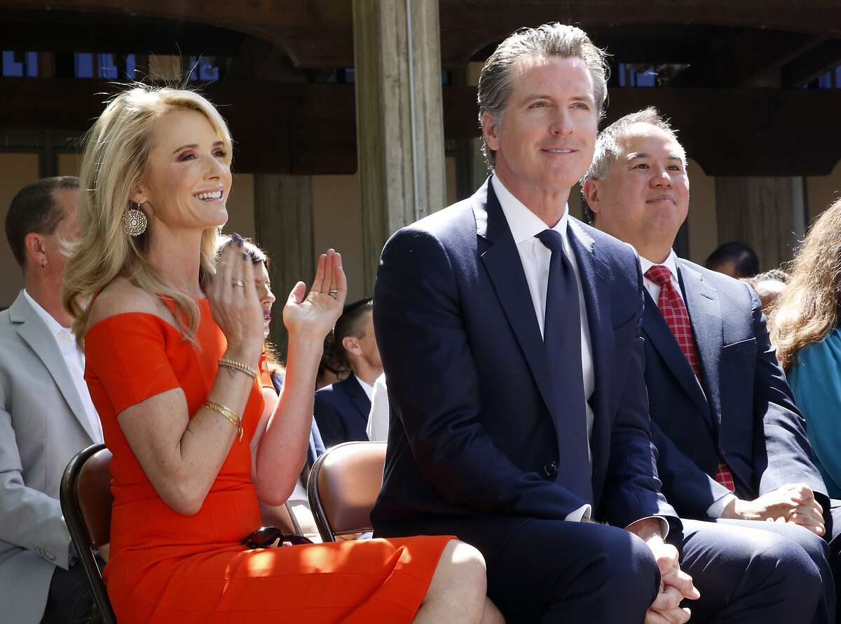 FILE -- In this July 1, 2019, file photo, First Partner Jennifer Siebel Newsom, left, attends a signing ceremony with her husband, Gov. Gavin Newsom, right, at Sacramento City College in Sacramento, Calif. The Newsoms made about $500,000 more in 2019, Gavin Newsom's first year as governor, than they did before, according to tax returns released on May 17, 2021. Newsom, a Democrat, has pledged to release his returns every year. (AP Photo/Rich Pedroncelli, File)