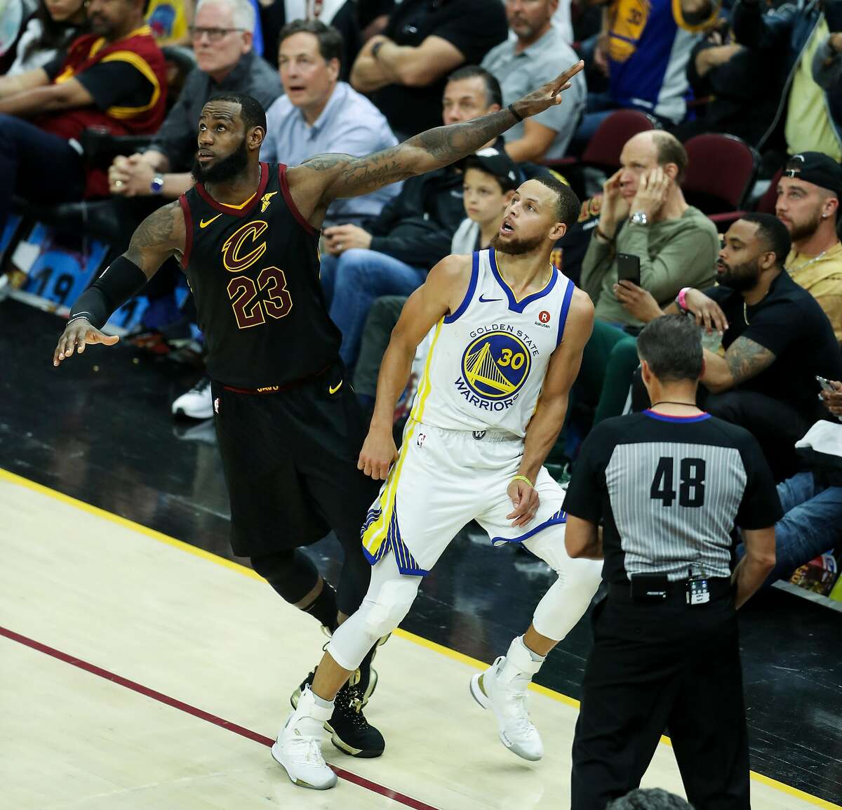 Golden State Warriors' Stephen Curry and Cleveland Cavaliers' LeBron James watch a Curry shot in the fourth quarter during game 4 of The NBA Finals between the Golden State Warriors and the Cleveland Cavaliers at Quicken Loans Arena on Friday, June 8, 2018 in Cleveland, Ohio.