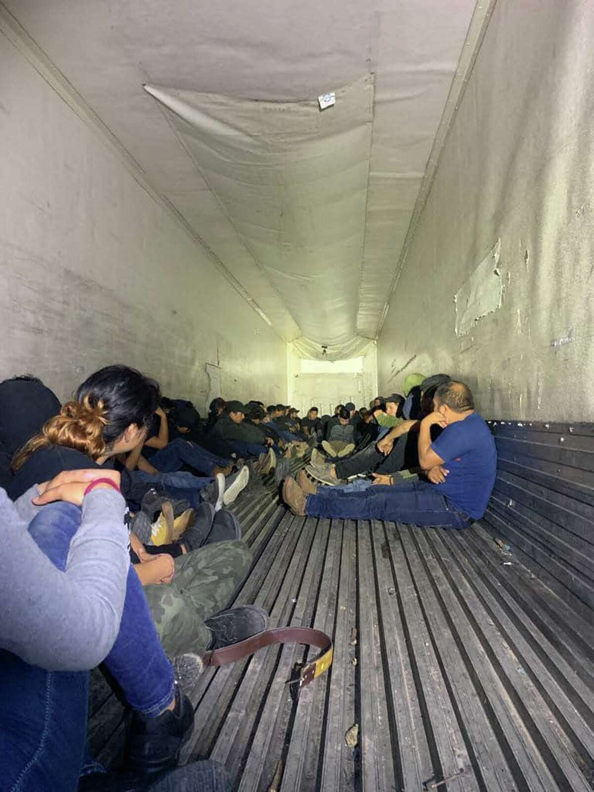 Federal and local authorities discovered 63 migrants inside a trailer.