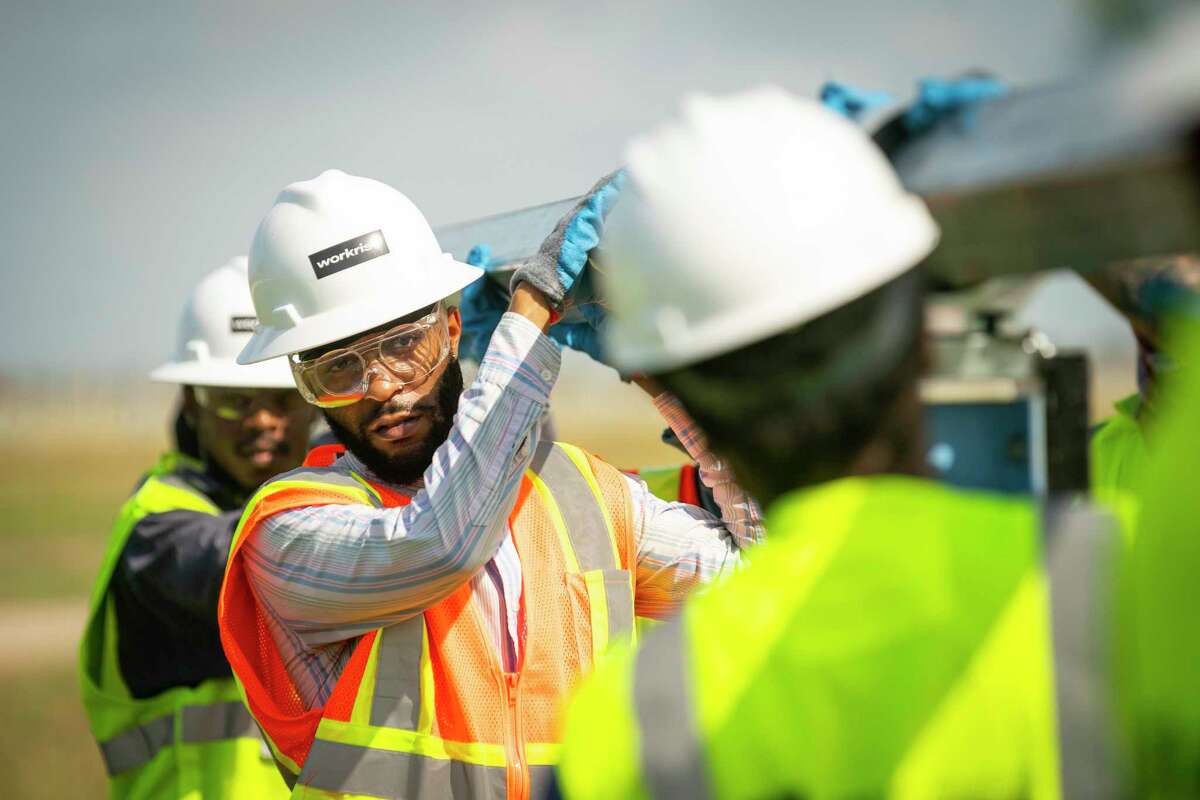 Quinton Buntin works to adjust a beam that will hold solar panels during a training class on installing the solar infrastructure, Tuesday, May 11, 2021, at a solar farm south of El Campo. Lone Star College has partnered with Workrise to provide free training for workers who want to work in the solar industry.