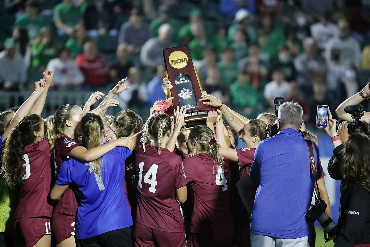 Santa Clara players hoist the championship trophy after their win over Florida State in the NCAA College Cup.