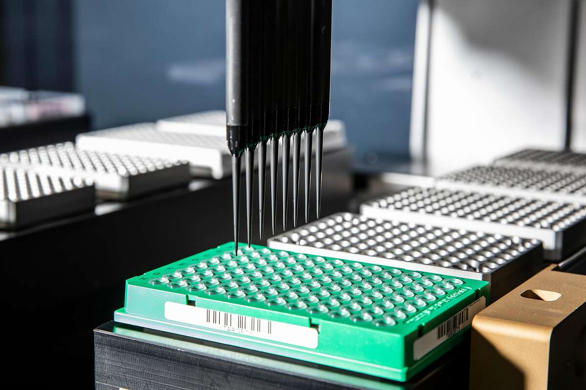 A Hamilton liquid handler used for genomic sequencing draws samples during a demonstration at a pre-polymerase chain reaction (PCR) lab at the Chan Zuckerberg Biohub in San Francisco, Calif., Thursday, May 13, 2021.