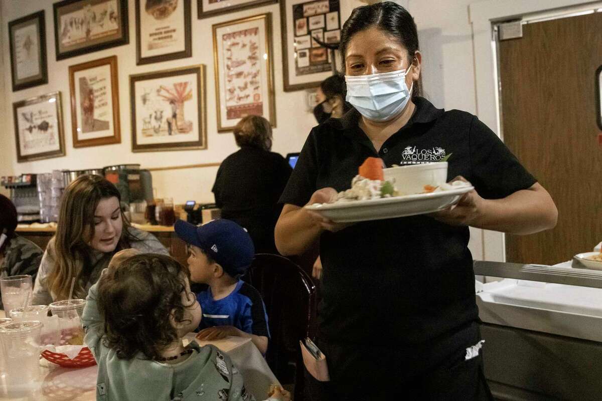 Dora Calderon serves customers at Los Vaqueros Restaurant in Fort Worth last month. Unemployment rates for Hispanics and Black Texans remain much higher than for whites and have not been declining in the same fashion, according to a recent Dallas Fed article. (Lynda M. González/The Dallas Morning News/TNS)