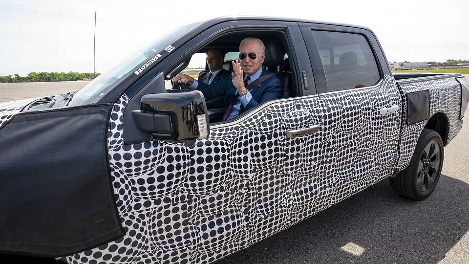 President Joe Biden waves from a Ford F-150 Lightning truck at the Ford Dearborn Development Center in Dearborn, Mich., Tuesday, May, 18, 2021. The new Ford F-150 Lightning truck is an electric powered vehicle. (Doug Mills/The New York Times)