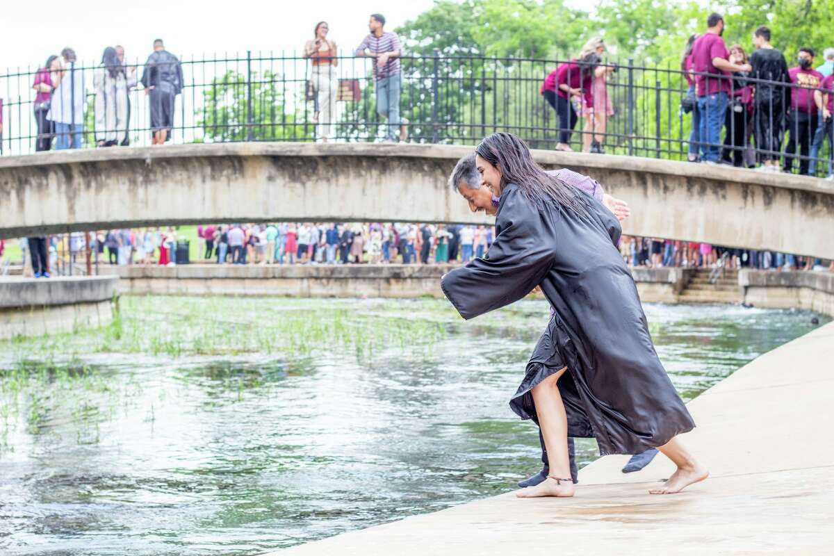 It's not a Texas State University graduation without a San Marcos River jump in full commencement garb and for one new alumna, it wouldn't be a milestone family moment, without her dad beside her in drenched pants and a button-down shirt. 