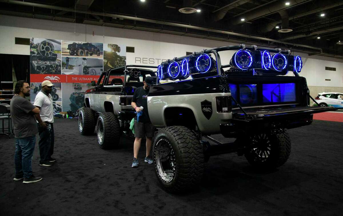 People awing a customized Chevrolet K5 Blazer with an audio trailer by Wet Sounds is photographed at the Houston Auto Show Tuesday, May 18, 2021, at NRG Center in Houston. The show opens on Wednesday, May 19 to Sunday, May 23.